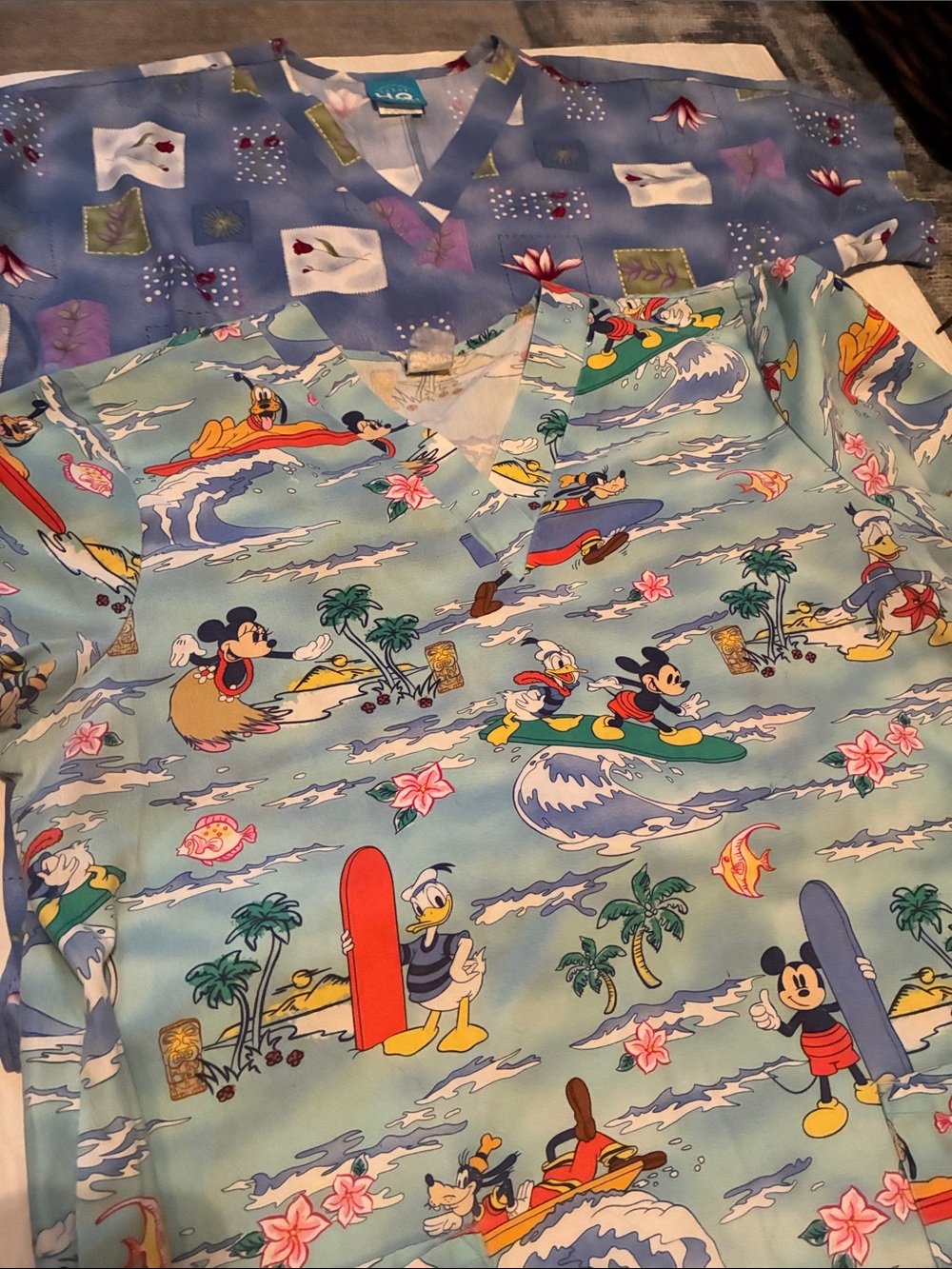 Two  Women ‘Scrubs One is Disney Micky Mouse  and one a Floral Background Size M